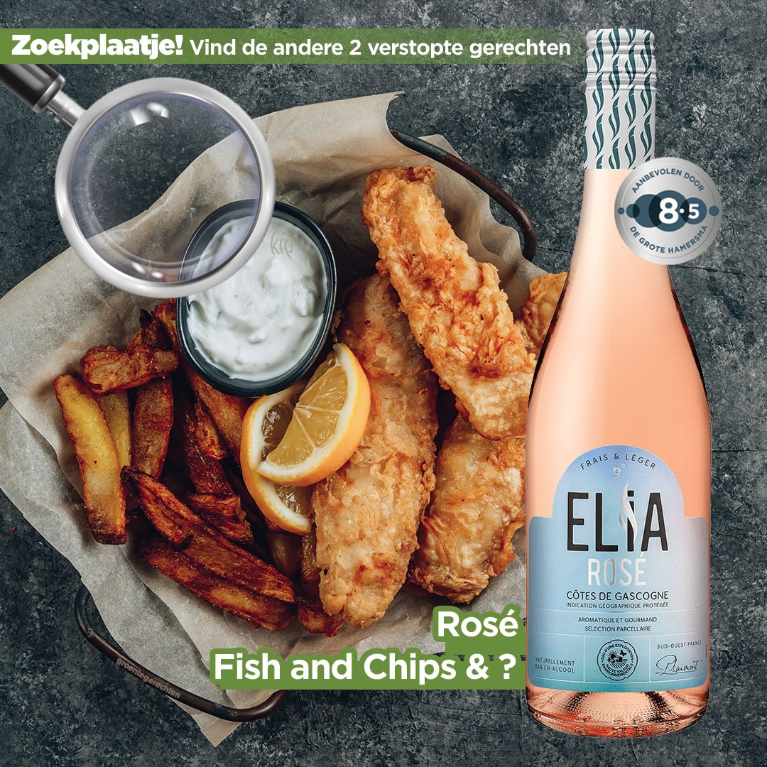 Overhead view of fried fish and chips with lemon wedges and dipping sauce, plus a magnifying glass and a pink Elisa rosé bottle on the right.